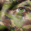 Camouflage painted on a face with green eye