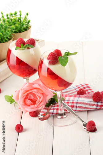 Photo: fruit jelly with raspberries in glasses on wooden table fruit jelly with raspberries in glasses on wooden table