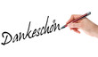 Foto: Hand mit Stift schreibt Dankeschön Hand mit Stift schreibt Dankeschön
