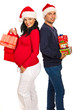 Happy couple holding Xmas gifts
