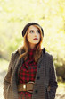 Style redhead girl at beautiful autumn alley.