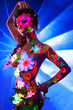Photo: Sexy woman with uv glowing make-up posing in dark Sexy woman with uv glowing make-up posing in dark