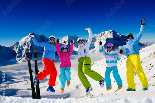 Photo: Ski, snow, sun and winter fun - happy family ski team Ski, snow, sun and winter fun - happy family ski team