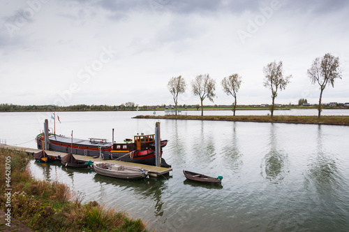 Photo: Dutch river on a cloudy day in in autumn Dutch river on a cloudy day in in autumn