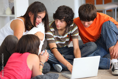 Photo: Teenagers looking at a computer screen Teenagers looking at a computer screen