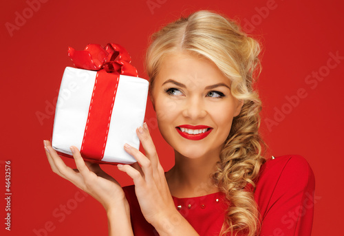 Photo: lovely woman in red dress with present lovely woman in red dress with present