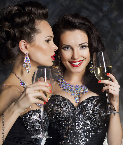 Photo: Christmas. Fashion women with wine glasses of champagne Christmas. Fashion women with wine glasses of champagne