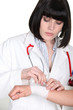 Doctor wrapping gauze around her patient's wrist