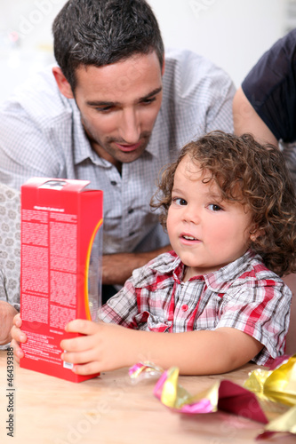 Photo: Little boy opening gift Little boy opening gift