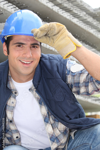 Photo: Smiling construction worker wearing a hardhat Smiling construction worker wearing a hardhat