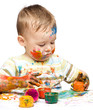 Little boy is playing with paints