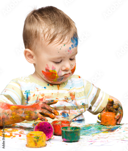 Photo: Little boy is playing with paints Little boy is playing with paints