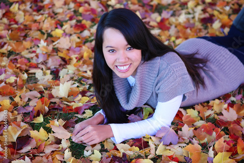 Photo: Asian Woman Laying in Leaves Asian Woman Laying in Leaves