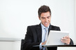 Young Businessman Using Digital Tablet In Office