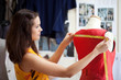 Fashion designer measuring a dress. Shallow depth of field.