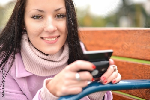 Photo: girl using smartphone girl using smartphone