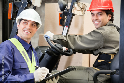 Photo: Portrait Of Forklift Driver With Supervisor Writing Notes Portrait Of Forklift Driver With Supervisor Writing Notes
