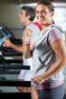 Woman And Man Running On Treadmill