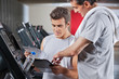 Photo: Instructor Guiding Man To Fill The Membership Form Instructor Guiding Man To Fill The Membership Form