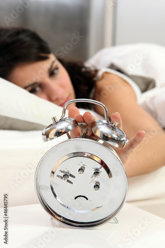 Photo: Woman turning off alarm Woman turning off alarm