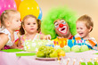 kids celebrating birthday party with clown