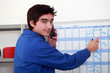 Plumber filling a wall diary