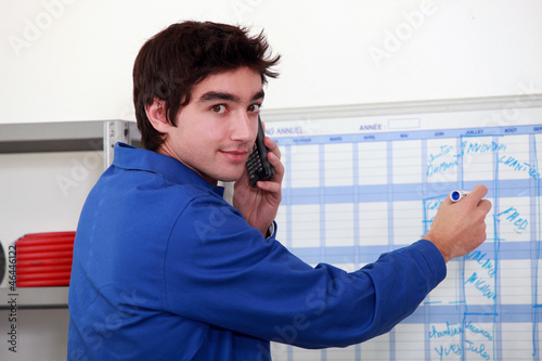 Photo: Plumber filling a wall diary Plumber filling a wall diary