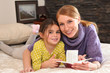 Mother and daughter reading book together