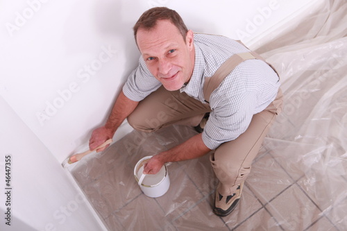 Photo: Man painting a wall Man painting a wall