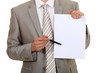 Businessman pointing to a blank sheet of paper