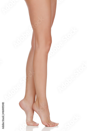 Photo: Beautiful woman legs against white background Beautiful woman legs against white background