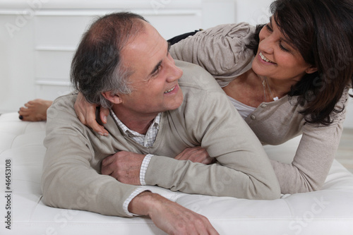 Photo: Mature couple lying on a bed Mature couple lying on a bed