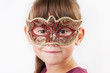 Charming girl in a carnival mask