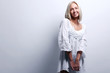 Shy  beautiful blonde dressed in nightgown smiling