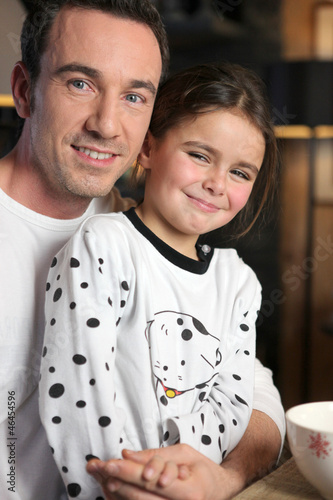 Photo: Man and little girl having breakfast Man and little girl having breakfast