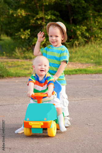 Photo: Two brothers, one with Down syndrome, have fun playing. Two brothers, one with Down syndrome, have fun playing.