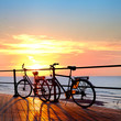 Two bikes on the beach. Sunset. Silhouette .