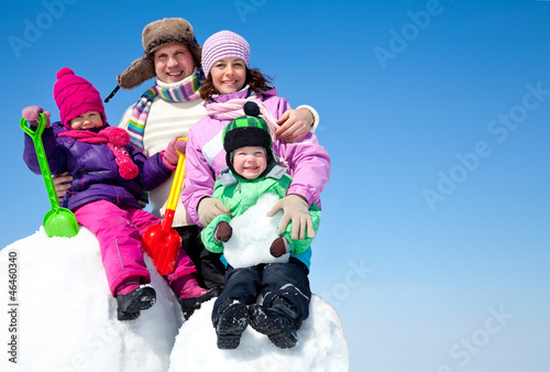 Photo: Happy family making snowman Happy family making snowman