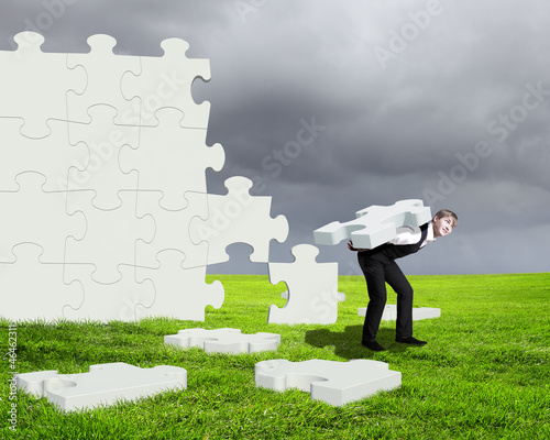 Photo: Businessman with a puzzle pieces Businessman with a puzzle pieces