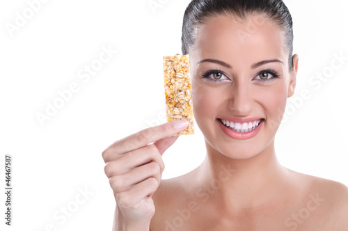 Photo: young woman with muesli bar young woman with muesli bar