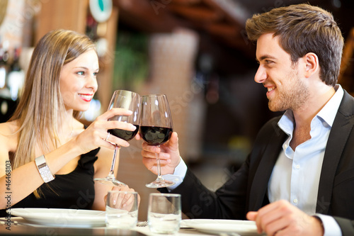 Photo: Couple in a romantic dinner toasting with wine Couple in a romantic dinner toasting with wine