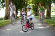 4 year old boy sitting on his bike in front of his family