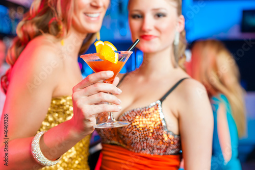 Photo: People in club or bar drinking cocktails People in club or bar drinking cocktails