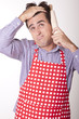 Photo: Handsome tired male cook with cooking equipment Handsome tired male cook with cooking equipment