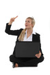 woman sitting on the floor with her laptop and having a idea
