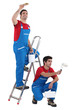 Two painter working on the same house