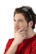 Pensive young man with sunglasses resting on his head