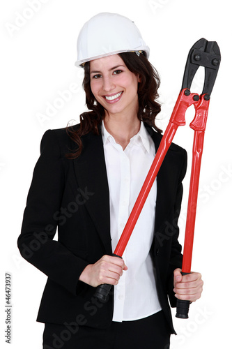 Photo: Corporate woman holding pliers. Corporate woman holding pliers.