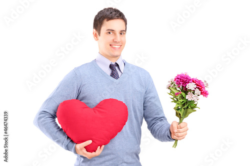Photo: A young man holding flowers and red heart A young man holding flowers and red heart