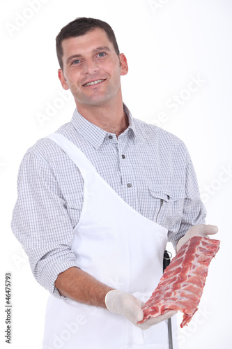 Photo: a butcher showing pork ribs a butcher showing pork ribs